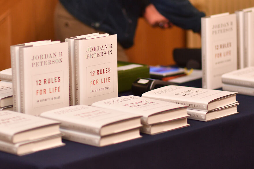 Books titled 12 Rules for Life by Jordan Peterson displayed on a table relating to Jordan Peterson’s net worth. Books titled 12 Rules for Life by Jordan Peterson displayed on a table relating to Jordan Peterson’s net worth.