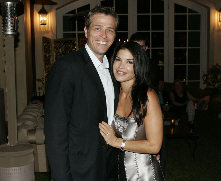 Lauren S&aacute;nchez in a throwback photo smiling with a man at a nighttime event, showcasing her youthful appearance.