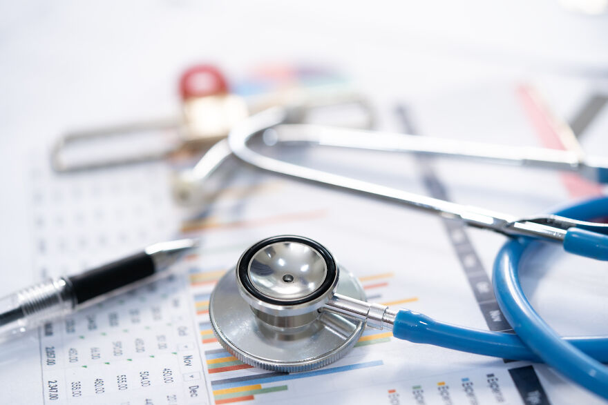 Stethoscope and pen on financial charts, illustrating no tax on overtime benefits for 2025 tax return boost.