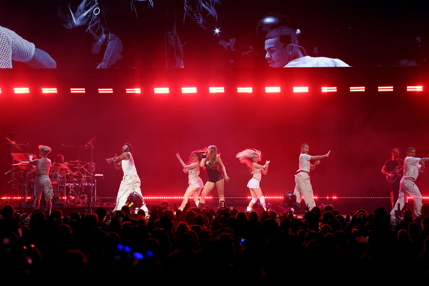 Tate Mcrae performing on stage with dancers and red lighting, showcasing her steady success on streaming platforms. Tate Mcrae performing on stage with dancers and red lighting, showcasing her steady success on streaming platforms.