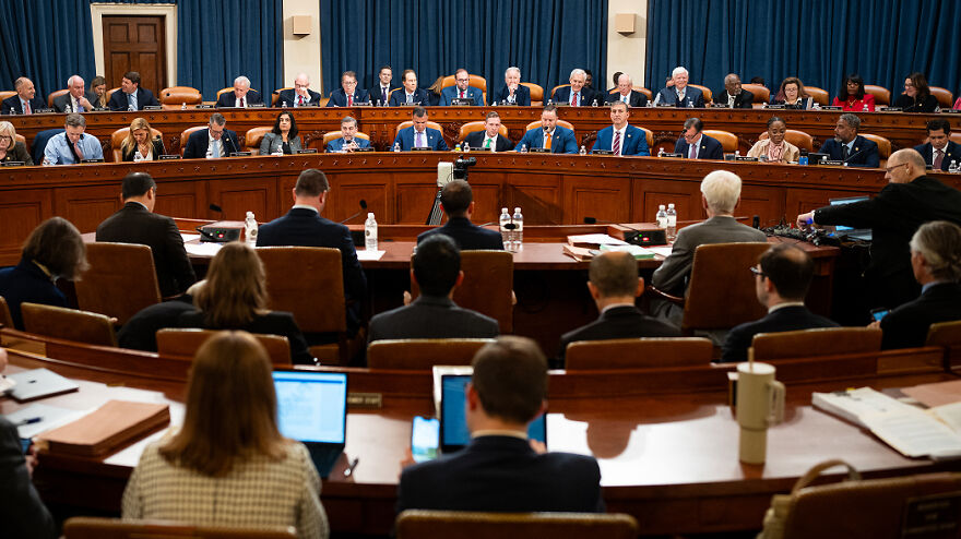 Government officials in a hearing room discussing tax policies related to no tax on overtime and 2025 tax returns.