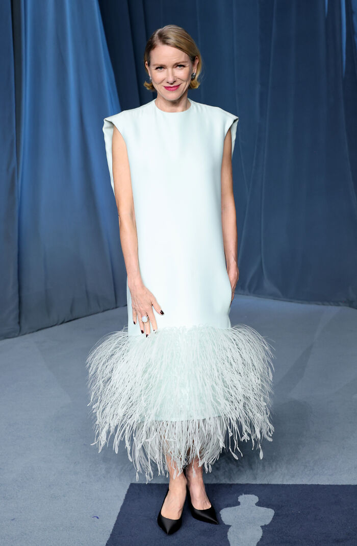 Woman in a pale blue feathered dress posing on the carpet showcasing must-see looks from the 2025 Academy Museum Gala red carpet.