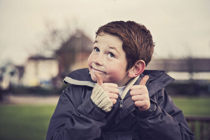 Young boy outdoors giving thumbs up with a playful smile, illustrating funny responses to how are you for dating and work. Young boy outdoors giving thumbs up with a playful smile, illustrating funny responses to how are you for dating and work.