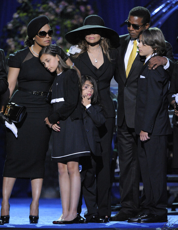 Family dressed in black at a memorial, highlighting Paris Jackson&rsquo;s shocking claim against Michael Jackson&rsquo;s estate turmoil.
