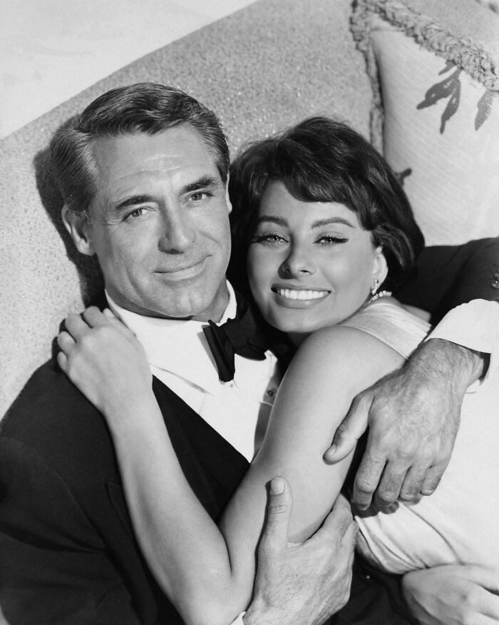 Sophia Loren smiling and embracing a man in a tuxedo, showcasing Italian beauty and Hollywood legend charm.