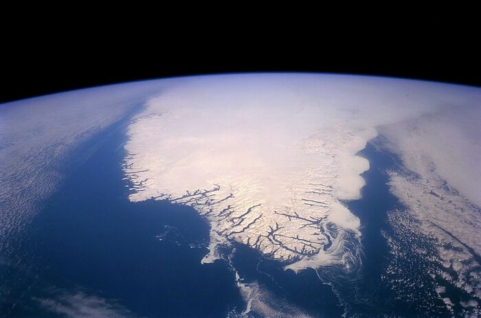 View of icy Greenland from space showcasing extreme weather records and the powerful forces shaping our planet’s climate.