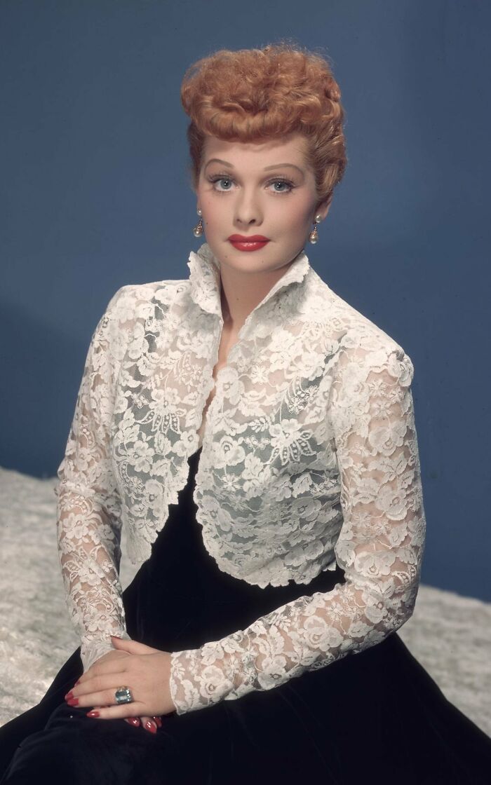 Classic Hollywood star in a white lace jacket and red hair, representing Hollywood stars who found fame after 30.