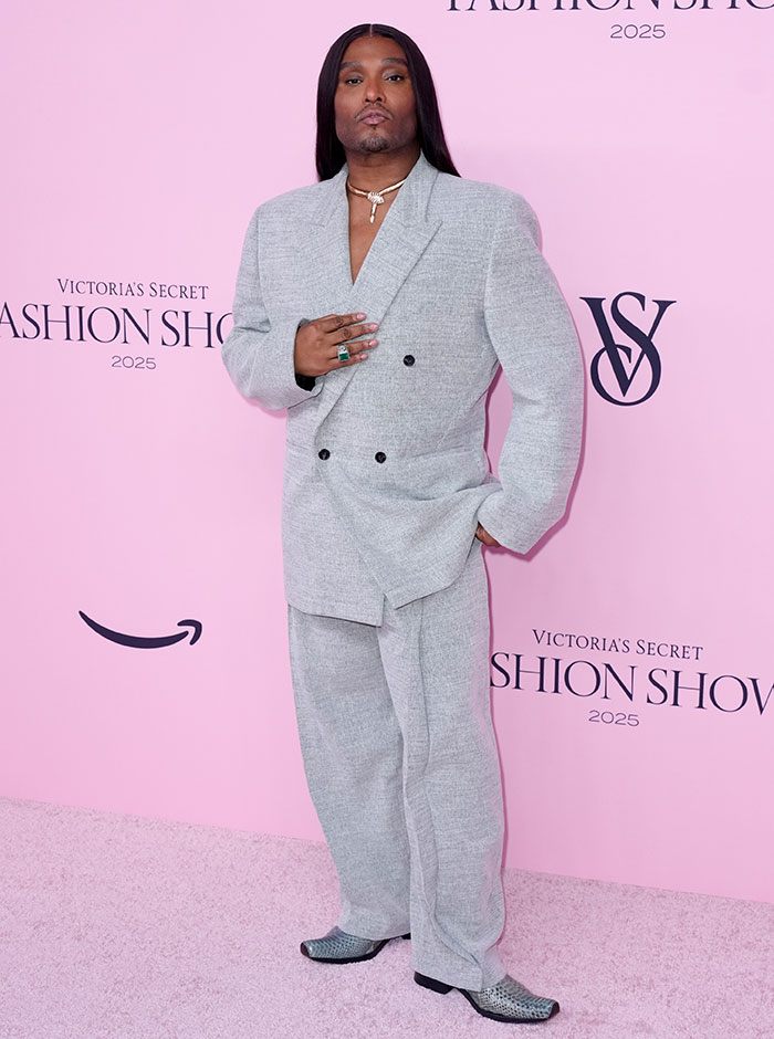 Person posing in an oversized gray suit at the Victoria's Secret fashion show with the worst dressed risqué looks 2025.