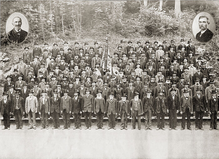 Large vintage group photo of men in suits and hats, a historical event captured among funny moments in history.