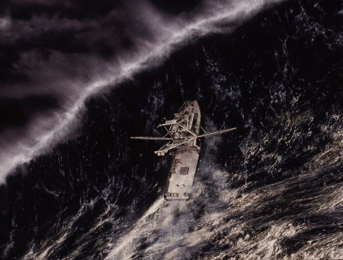 Ship struggling in stormy ocean waves, representing intense scenes from movies based on true stories impossible to believe.