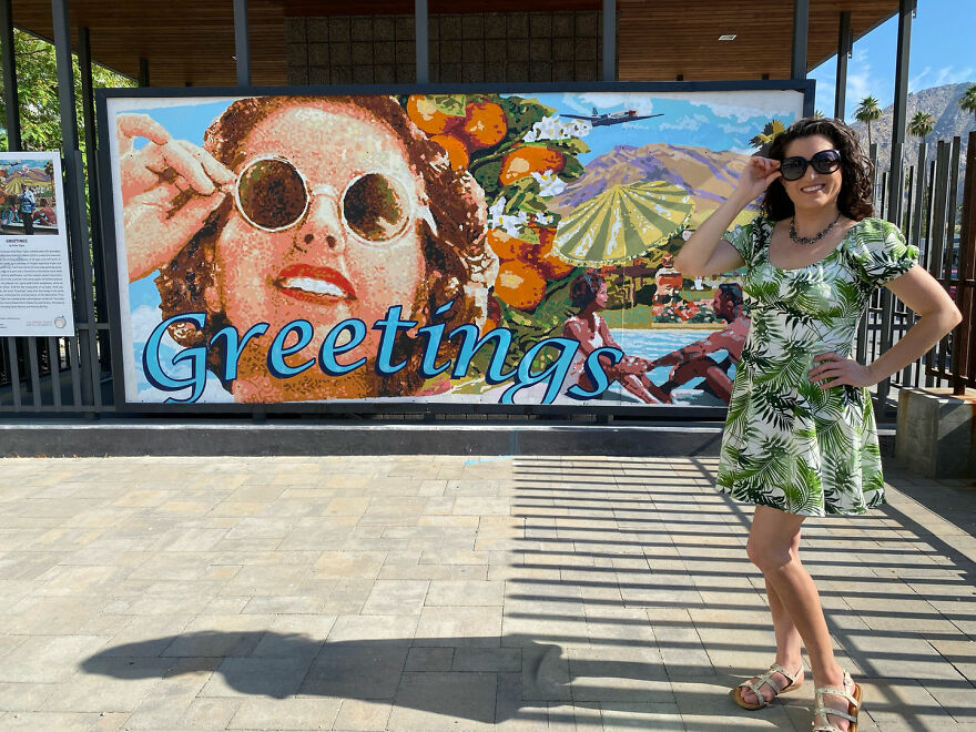 Woman posing by a colorful mural outdoors, part of a billboard campaign to find love attracting many responses.