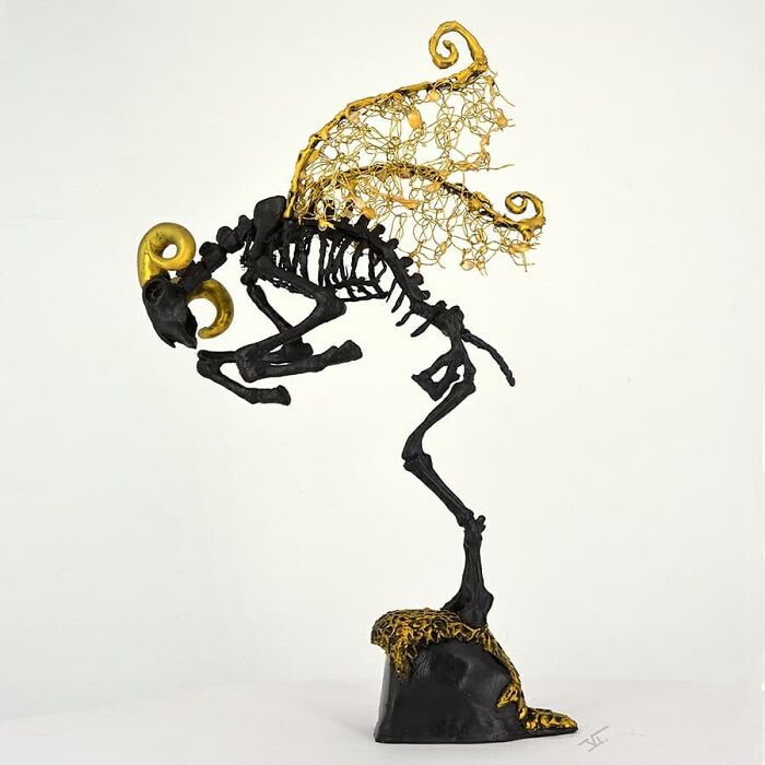 Haunting porcelain sculpture of a mythical creature with golden horns and delicate wire wings resembling relics of forgotten myths.