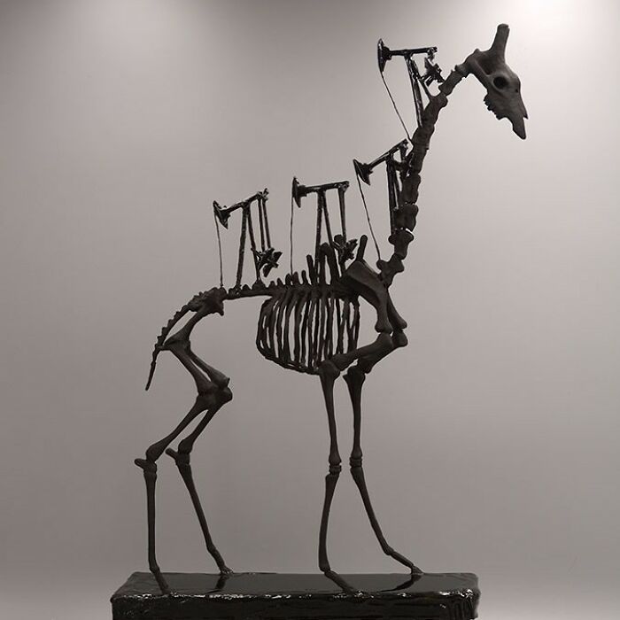 Porcelain sculpture of a haunting skeletal creature with mechanical elements resembling relics of forgotten myths.