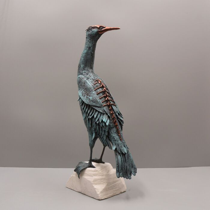 Porcelain sculpture of a haunting bird with exposed rib-like details, resembling relics of forgotten myths.