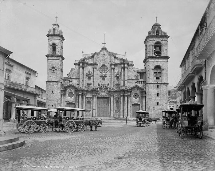 Historic photo of a world capital showing old horse-drawn carriages and colonial architecture before modern times.