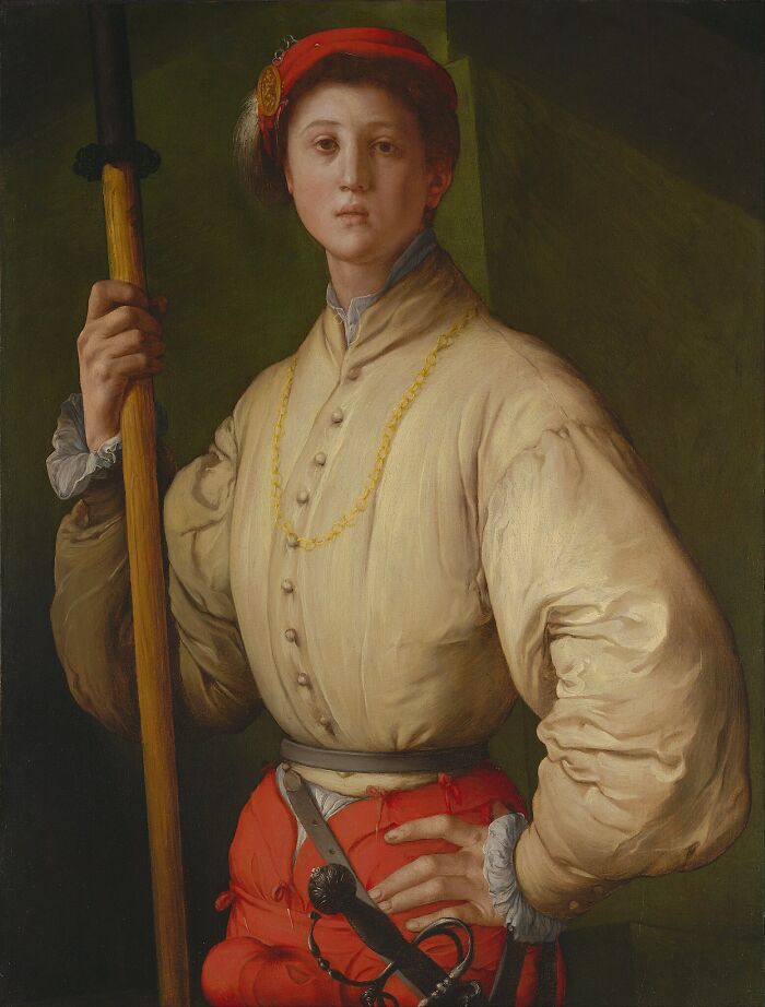Portrait of a young man in Renaissance attire holding a staff, a famous painting that changed art forever.