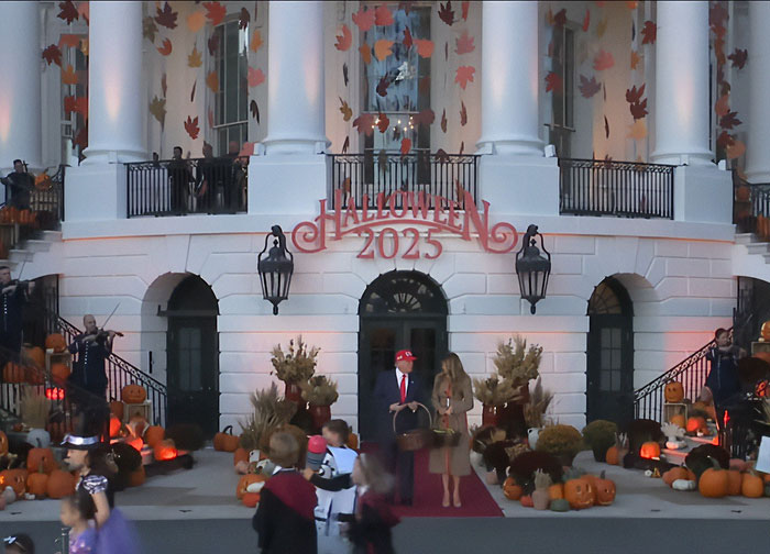 White House Halloween display with pumpkins and autumn leaves featuring Melania Trump's controversial decorations in 2025.