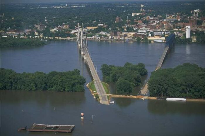 A flooded bridge and river scene illustrating unexpected historical events like rabbits attacking Napoleon.