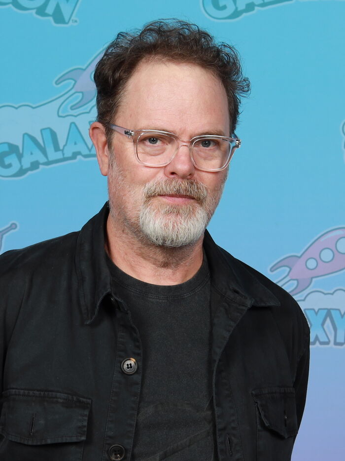 Middle-aged Hollywood star with glasses and beard posing at event, representing actors who found fame after 30 years old.