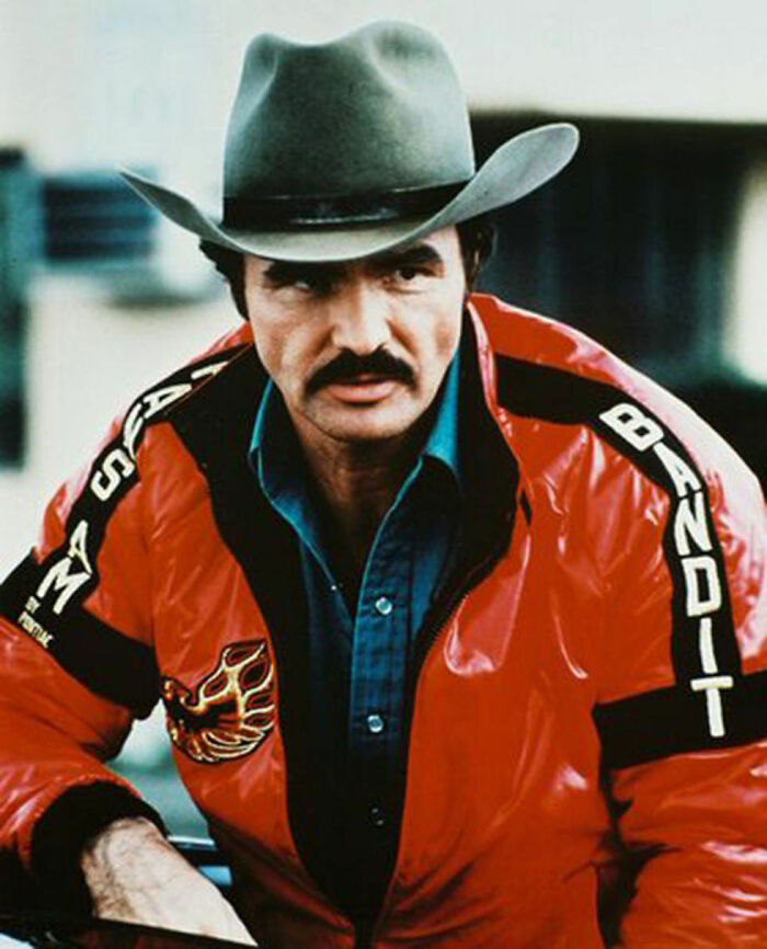 Actor wearing a cowboy hat and red jacket with bandit text, representing Hollywood stars who found fame after 30.
