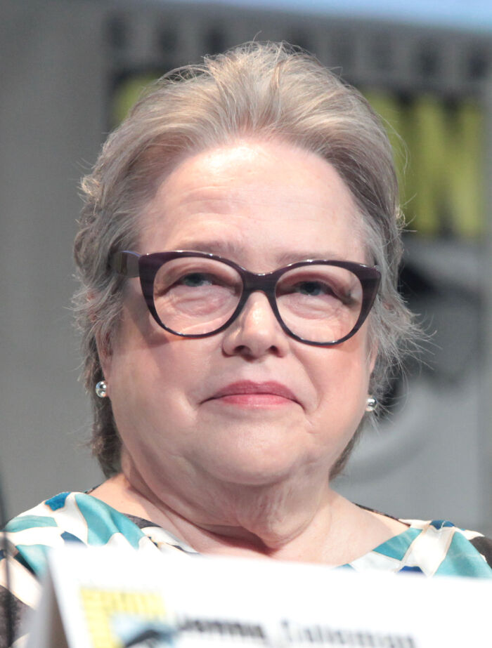 Close-up of a mature Hollywood star wearing glasses, representing actors who found fame after 30 years old.