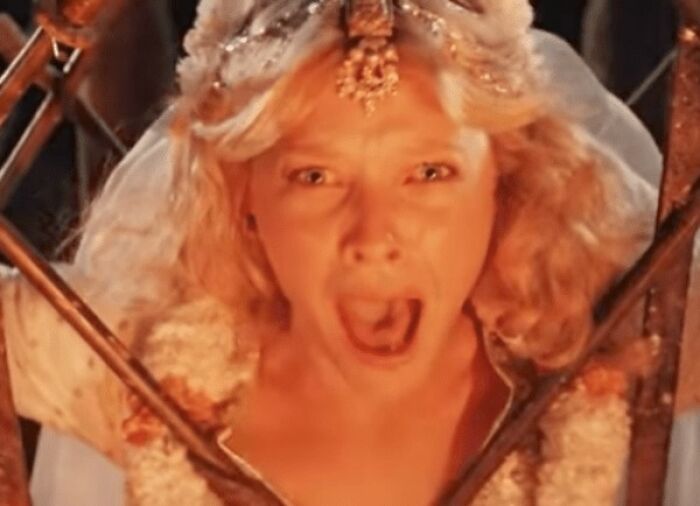 A woman with blonde hair in a dramatic scene, representing unrealistic women movie tropes that still annoy viewers.