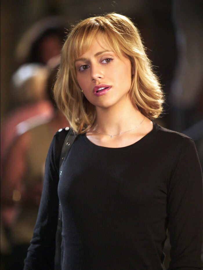 Young woman with blonde hair wearing a black top, representing true crime fans expressing bold opinions.