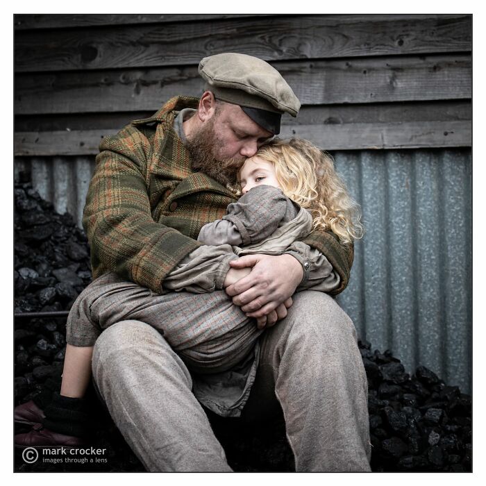 Father in vintage clothing hugging his child, capturing a beautiful moment of childhood around the world.