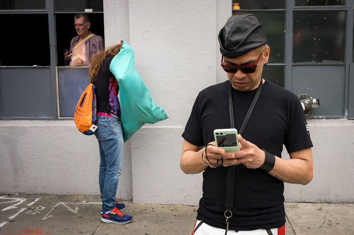 Street photographer captures humor and chaos in everyday life with candid shots of people in urban settings.