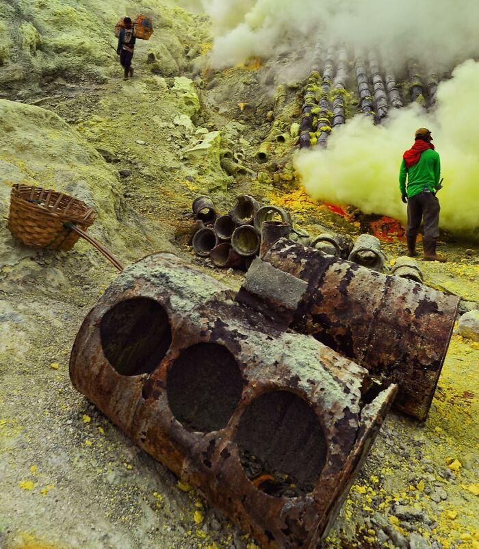 Sulfur miners at work in a smoky volcanic landscape, captured through candid photos showing life’s beauty.
