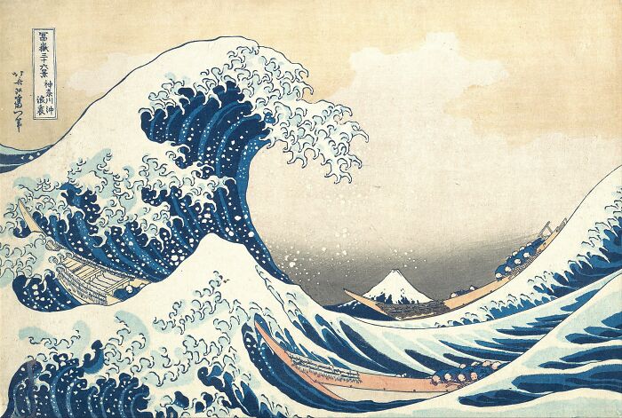 Famous painting of a large ocean wave with boats and Mount Fuji in the background, a masterpiece that changed art forever.