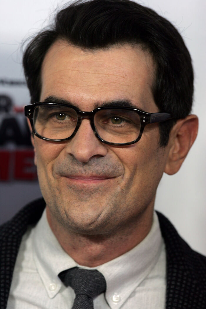 Close-up of a Hollywood star wearing glasses and a tie, representing actors who found fame after 30.