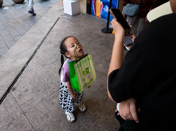 Child with a shopping bag caught in a street coincidence moment, illustrating quirky and captivating street coincidences.