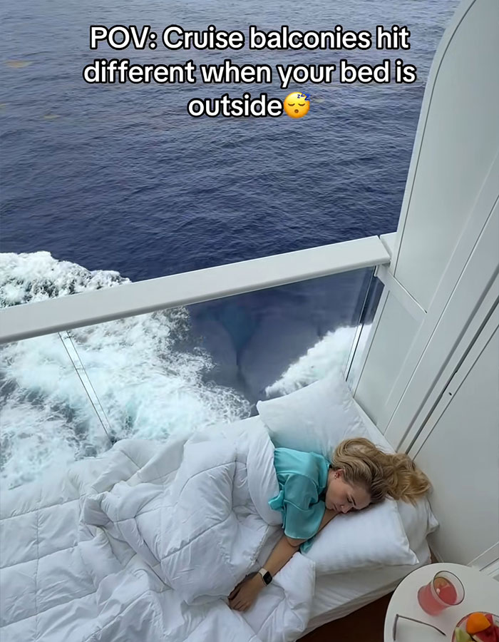 Woman sleeping on a cruise balcony bed overlooking ocean waves in viral video of strangers sleeping on cruise balcony debate