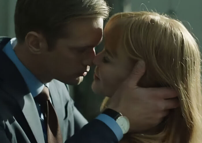 A man gently holding a woman&rsquo;s face as they lean in for an intimate moment, highlighting intimacy themes.