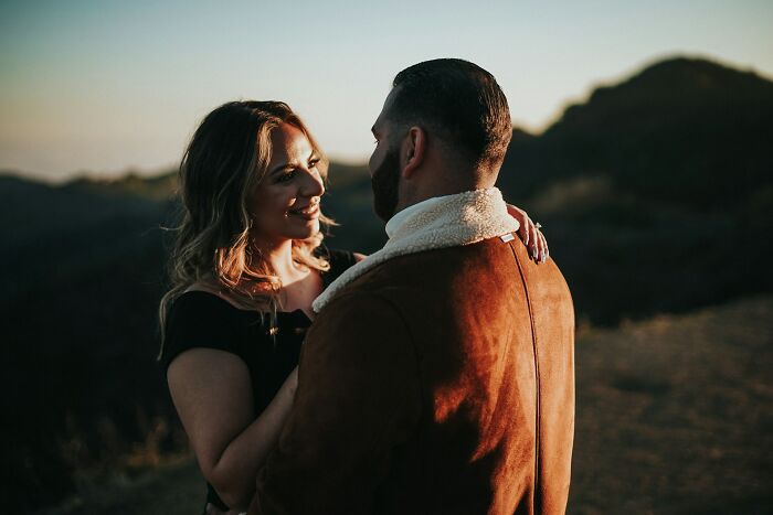 Couple embracing outdoors during sunset, sharing a moment of connection and relationship advice for lasting love.