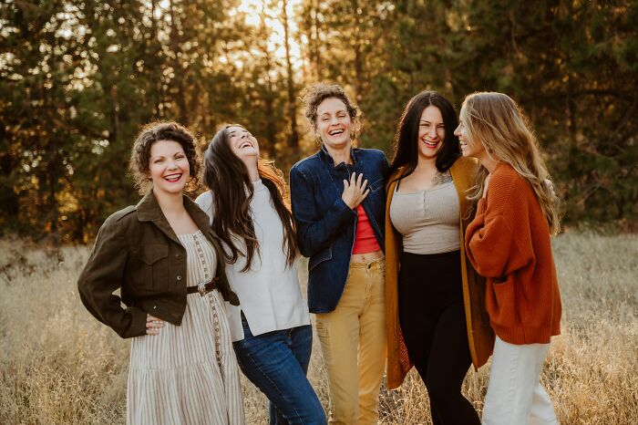 Group of five women laughing outdoors, capturing the fun and savage responses in the internet's favorite game brand.