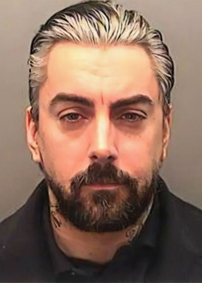 Mugshot of a rock star involved in prison attack while serving a sentence for crimes against children.