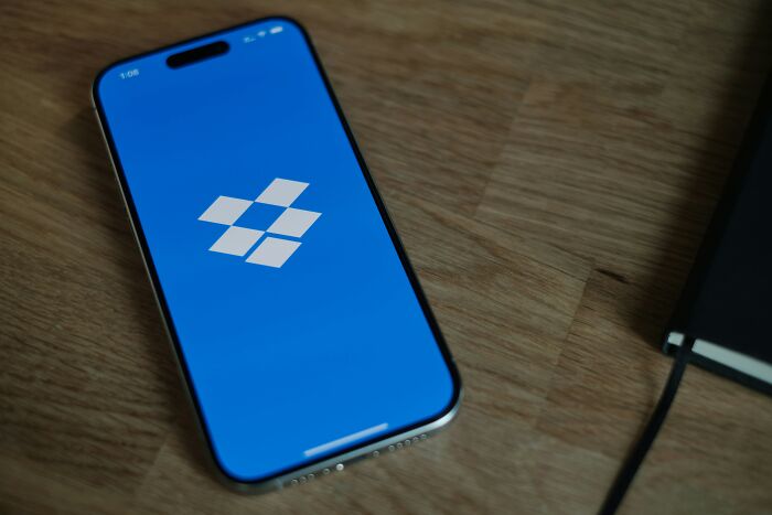 Smartphone displaying a blue screen with an app logo.