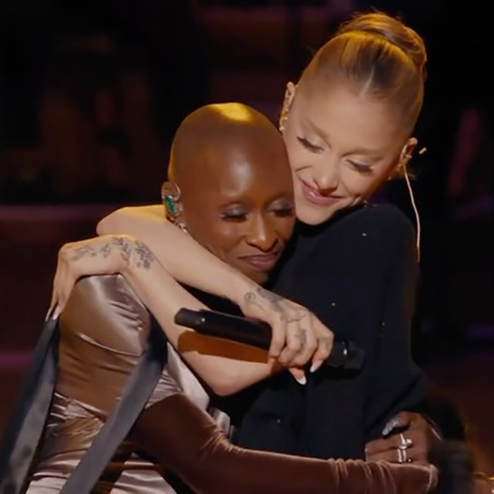 Ariana Grande embracing a fellow performer on stage, showcasing her dramatic new look amid fan backlash.