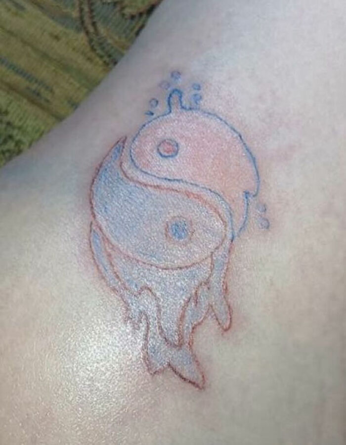 Yin yang tattoo with melting effect on skin showing unusual and unique tattoo design on body.