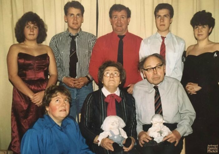 Vintage family photo with formal outfits and awkward poses, capturing cringe-worthy moments in family photo collections online.