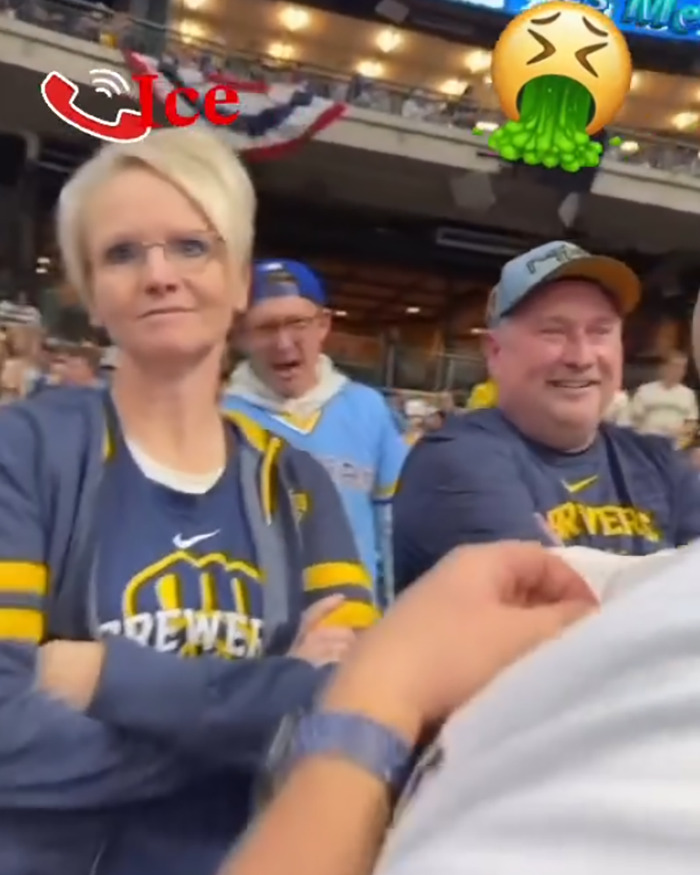 Woman wearing a Brewers jersey at a baseball game, involved in incident leading to firing after racist rant at war veteran.