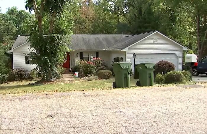 Suburban house with trees and bushes outside where sister&rsquo;s emotional reaction follows missing brother found alive in basement.