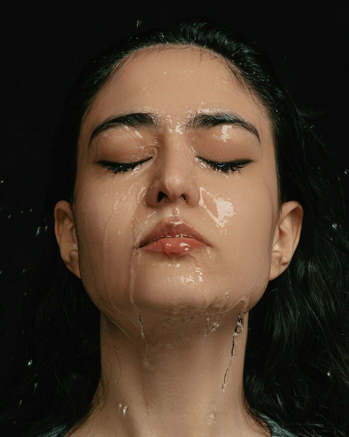 Close-up of a woman with eyes closed as water flows down her face, illustrating the theme of drunk fumbles and bad decisions.