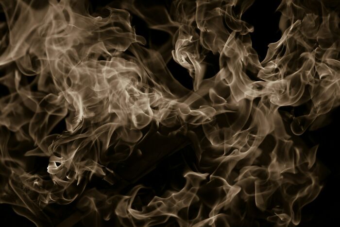 Smoke swirling in dark background representing terrifying medical conditions that can end someone without symptoms