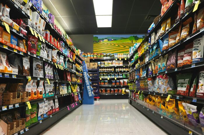 Grocery store aisle filled with snacks and chips.