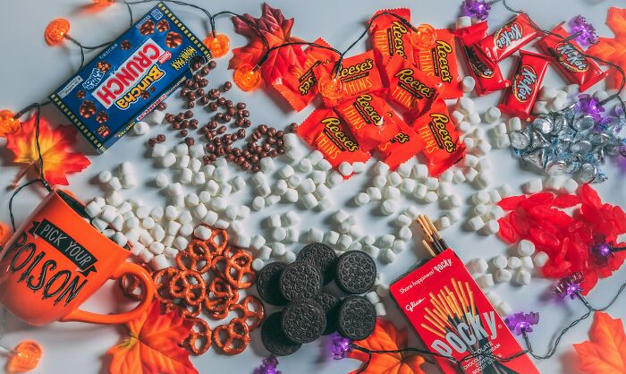 Assortment of candy and snacks with autumn leaves, illustrating common truths people were fooled into believing propaganda.