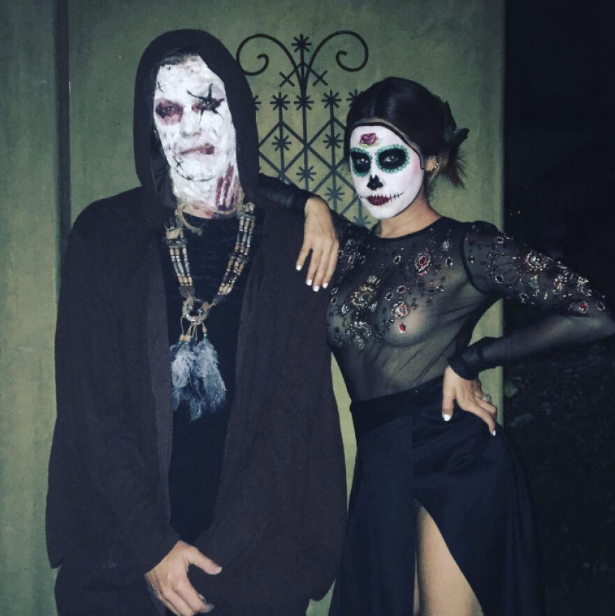 Two celebrities in Halloween costumes with detailed skull face paint, showcasing creative celebrity Halloween costume ideas.