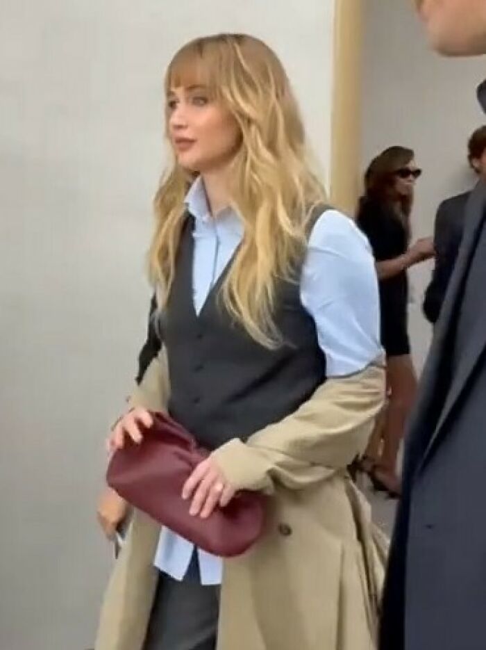 Jennifer Lawrence at Paris Fashion Week, sparking frenzy with bold style amid calls to arrest every plastic surgeon in LA.